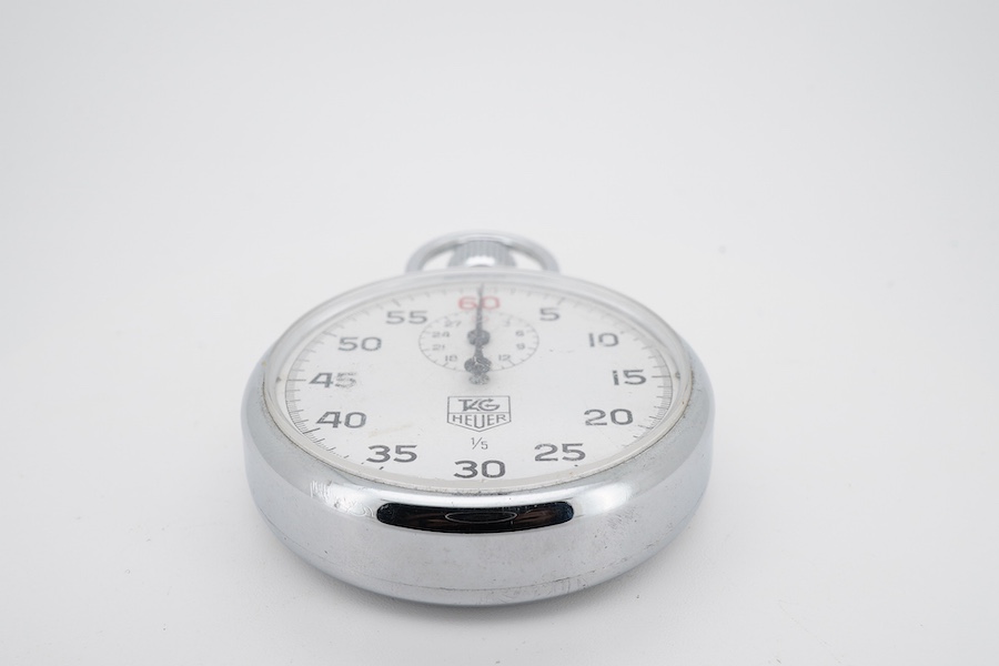 A chrome cased Tag Heuer stopwatch, the back with original red sticker, case diameter 50mm.